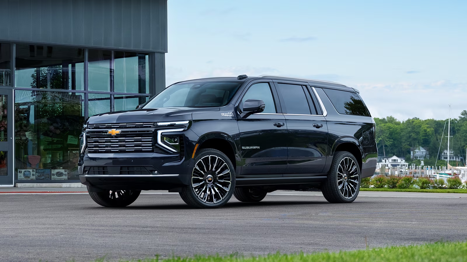 Black luxury SUV on a coastal road at dusk